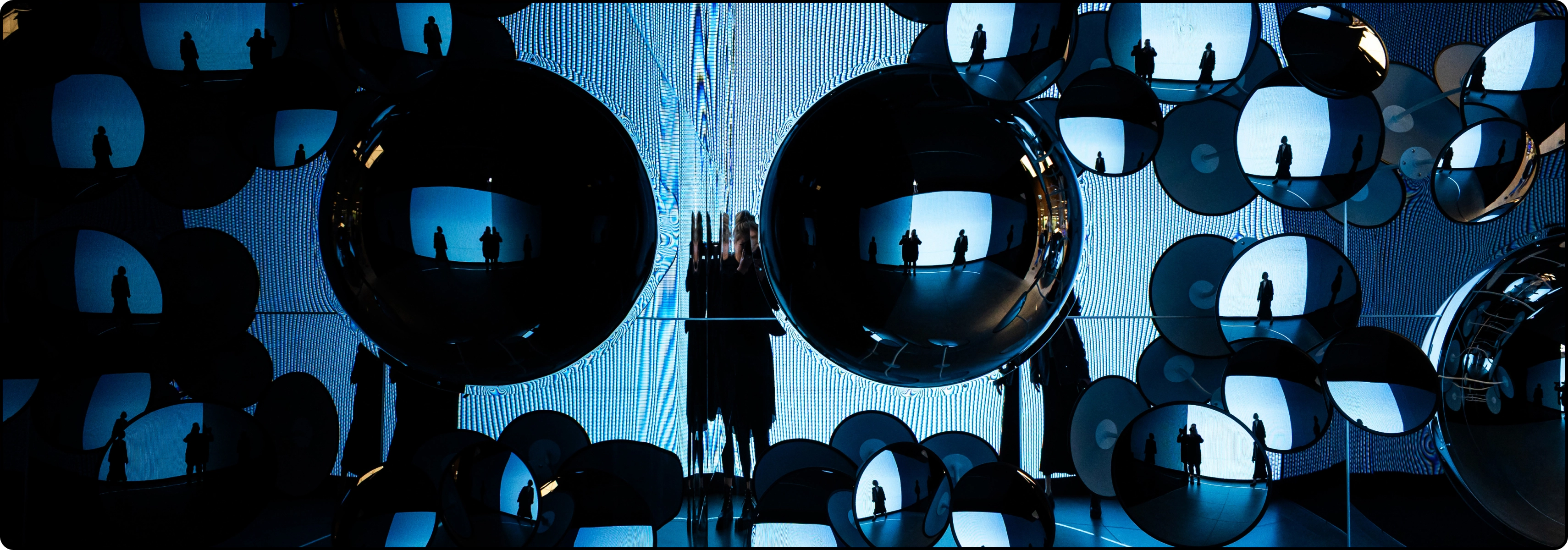 KTU Lifelong Learning page &ldquo;FAQ&rdquo; banner &ndash; blue reflections and human silhouettes in mirrored spheres, symbolising questions and answers.