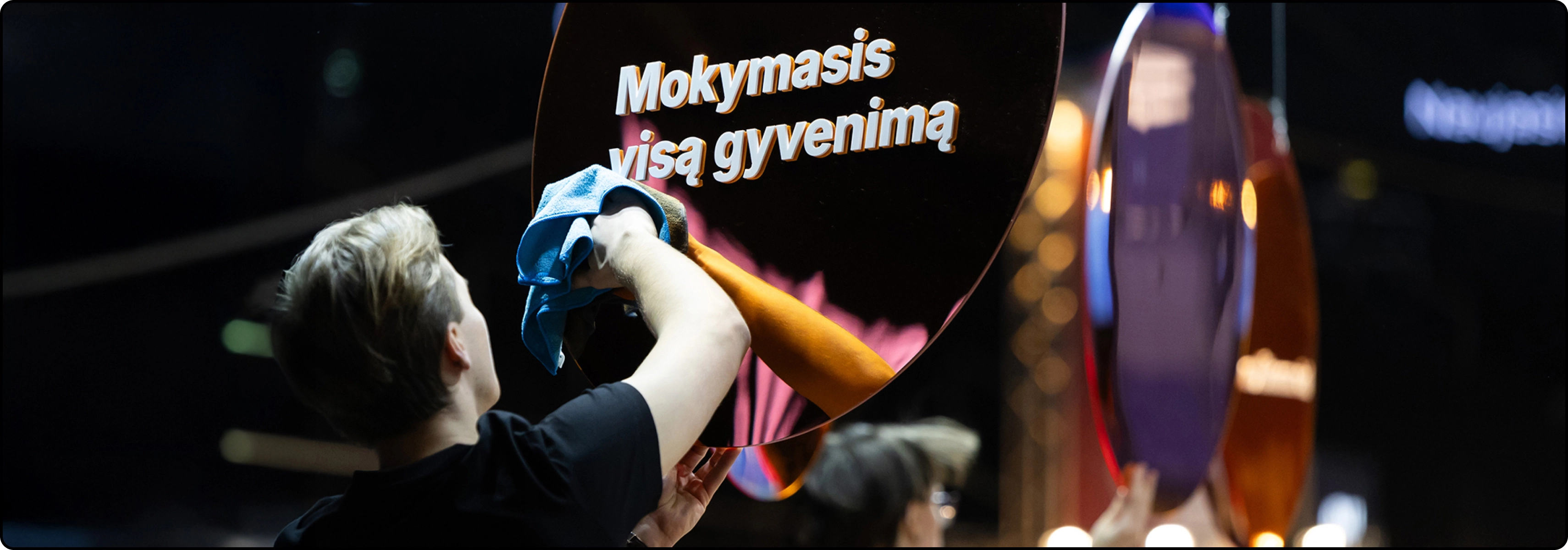 KTU Lifelong Learning page &ldquo;Why Us&rdquo; banner &ndash; a person cleaning a shiny round surface with the text &ldquo;Lifelong Learning.&rdquo;