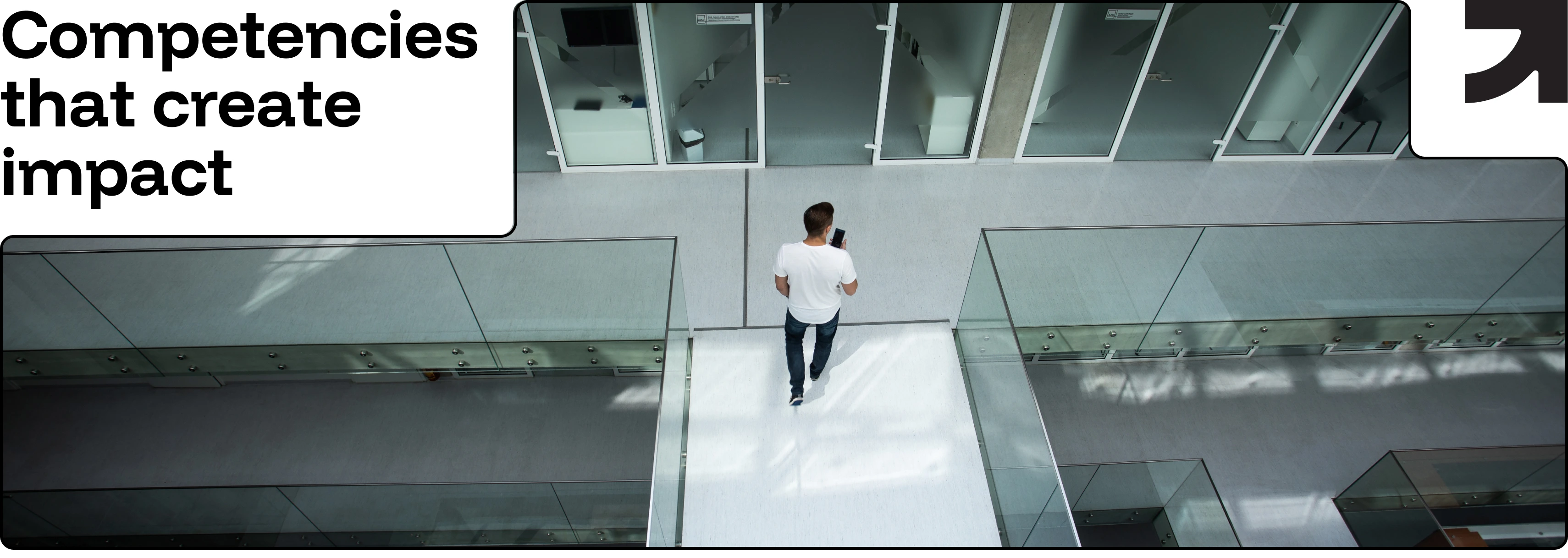 Career and Bussiness “Competencies that create impact” — a man walking alone in a modern glass corridor, viewed from above.