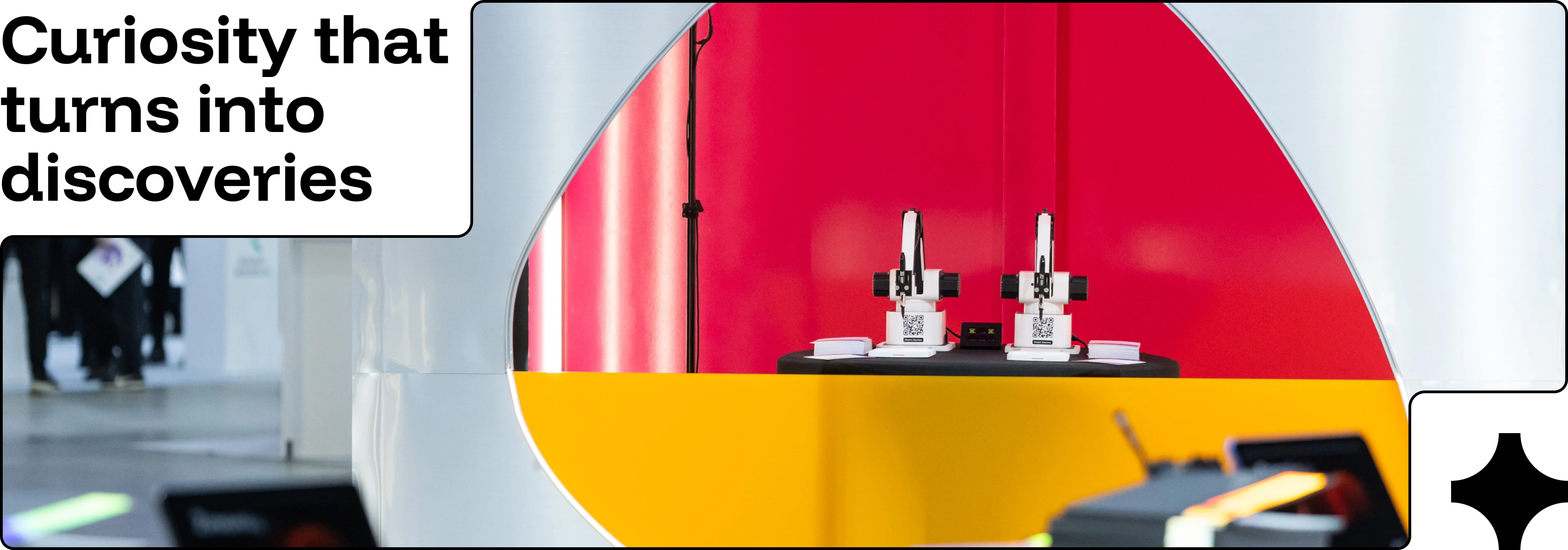 A modern lab scene with robotic devices and bold red&ndash;yellow tones, paired with the headline &ldquo;Curiosity that turns into discoveries&rdquo; to highlight innovation and exploration.